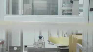 İlaç içeren karton kutu ilaç fabrikasının atölyesinde metal otomatikler üzerinde hareket ediyor. Eczacılık kimya şirketinde, uyuşturucu kullanımına yakın görünüm, iş süresince taşıyıcı bant boyunca ilerler