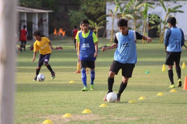 Yeni Delhi, Delhi / Hindistan - 15 Haziran 2020: Yeni Delhi 'deki tecrit bittikten sonra yeşil alanlarda futbol oynayan genç çocuklar.