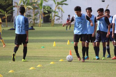 Yeni Delhi, Delhi / Hindistan - 15 Haziran 2020: Yeni Delhi 'deki tecrit bittikten sonra yeşil alanlarda futbol oynayan genç çocuklar.