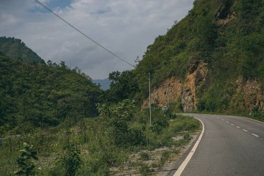 Dağlardaki kayalık bir patikanın manzarası ağaçlarla kaplı, sonbahar rengi.