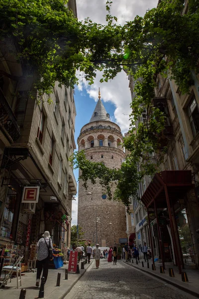 ISTANBUL / TURKEY - 07.17.2020: Bulutlu bir yaz gününde Galata Kulesi, İstanbul, Türkiye 'nin başlıca simgelerinden biri