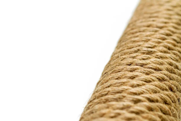 sisal rope cat scratching post on white background. Selective focus, copy space for text