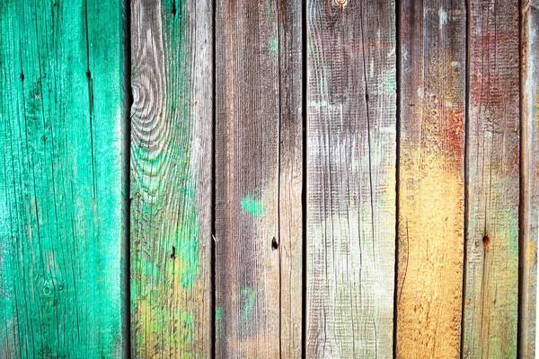 Tło starych drewnianych desek z gwoździami, zielone i żółte plamy farby na teksturowanej deski drewnianej. — Zdjęcie stockowe