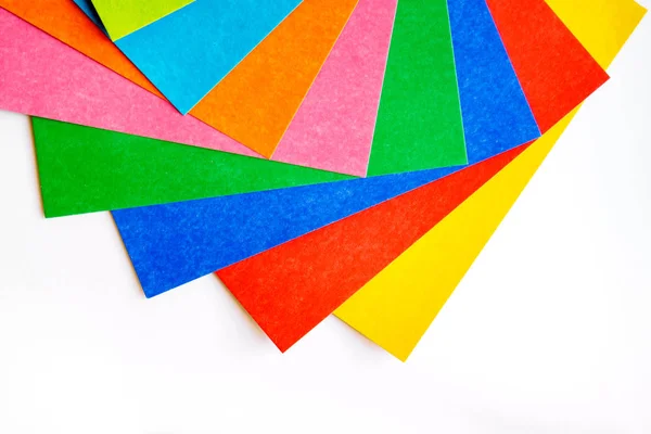 Many various colorful sheets of cardboard on a white background, top view — Stock Photo, Image