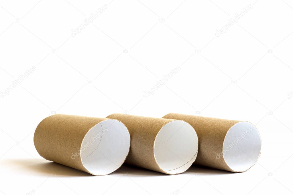 Three cardboard paper tubes in the row on white background. Close-up of empty toilet rolls, copy space