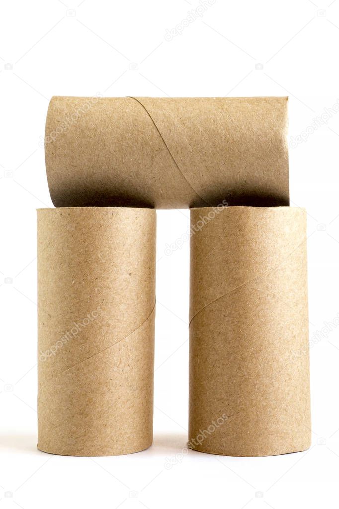 Composition from three cardboard paper tubes on white background. Close-up of empty toilet rolls