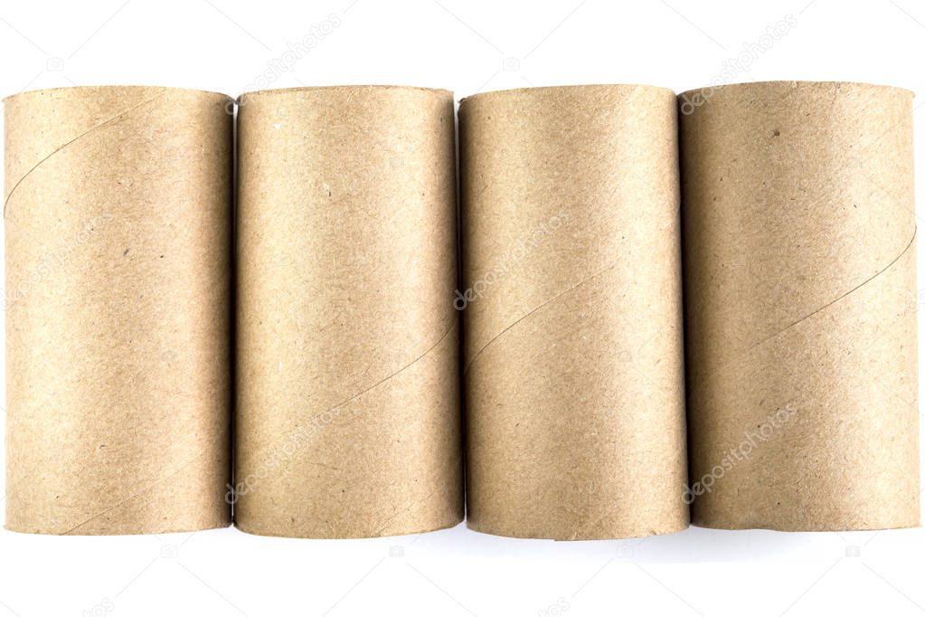 Top view of four cardboard paper tubes in the row on white background. Close-up of empty toilet rolls