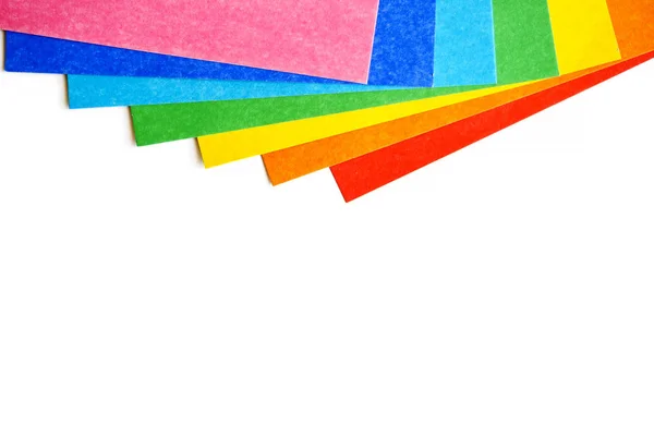 Heap of various colorful sheets of cardboard on a white background. Top view, copy space — Stock Photo, Image