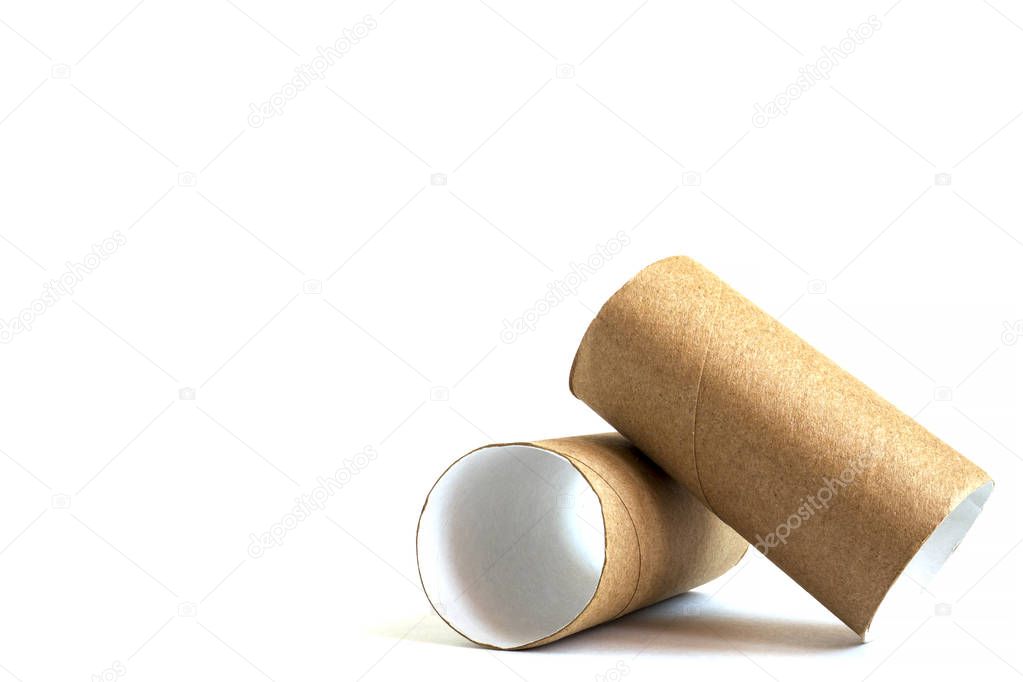 Composition from two cardboard paper tubes on white background. Close-up of empty toilet rolls, copy space