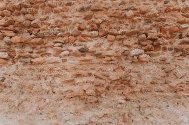 Taş duvar dokusu, arka plan, çağımıza kadar korunmuş tarihi eski taş, taşlar eşit şekilde yerleştirilmiş, katı yapı yüzyıllardır ayakta duruyor, antik binalar, binalar ve kalıntılar