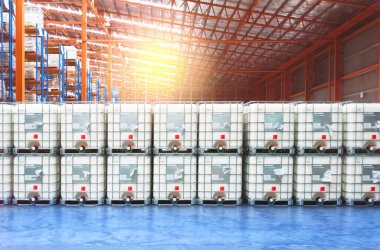 Liquid storage tank stack inside distribution warehouse. Industrial warehousing and logistics. Storage tank. clipart