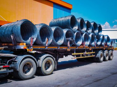 Truck receive steel wire rod from warehouse container unstuffing area. Coils of steel wire rod on truck trailer at industrial zone.  clipart