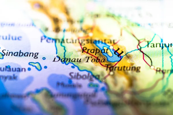 Shallow depth of field focus on geographical map location of Lake Toba in Indonesia Asia continent on atlas