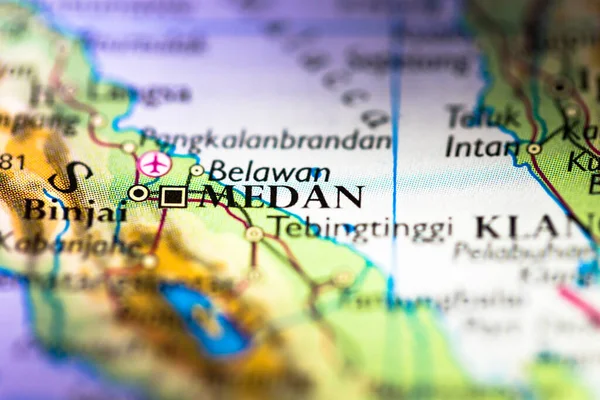 Shallow depth of field focus on geographical map location of Medan city in Indonesia Asia continent on atlas