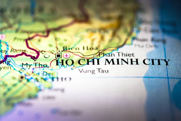 Shallow depth of field focus on geographical map location of Ho Chi Minh city in Vietnam Indochina Asia continent on atlas