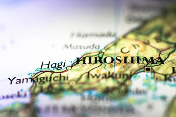 Shallow depth of field focus on geographical map location of Hiroshima city in Honshu Island Japan Asia continent on atlas