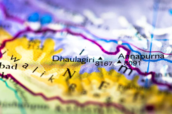 Shallow depth of field focus on geographical map location of Mount Annapurna Dhaulagiri in Nepal in Asia continent on atlas