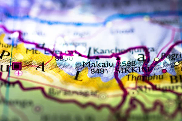 Shallow depth of field focus on geographical map location of Mount Makalu in Nepal in Asia continent on atlas