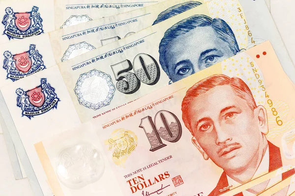 Currency banknotes spread across frame singapore dollar in various denomination