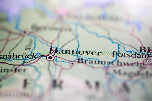 Shallow depth of field focus on geographical map location of Hannover city Germany Europe continent on atlas