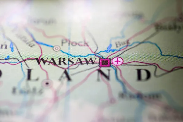Shallow depth of field focus on geographical map location of Warsaw city Poland Europe continent on atlas