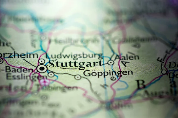 Shallow depth of field focus on geographical map location of Stuttgart city Germany Europe continent on atlas