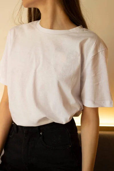 A young woman in a white t-shirt. For a clothing brand. Mock up.