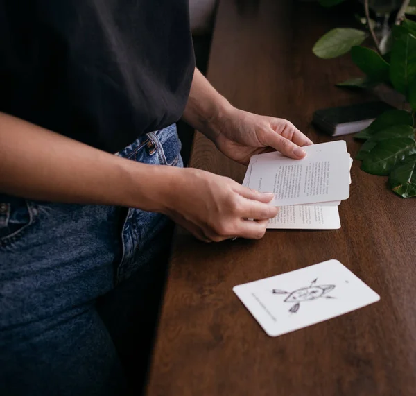 woman with tarot cards in hands