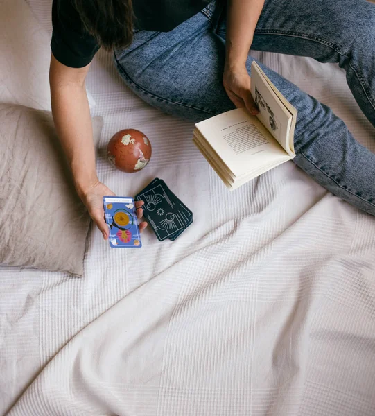 woman with tarot cards in hands