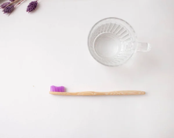 Pink Bamboo Toothbrush Glass Water Flowers — Stock Photo, Image