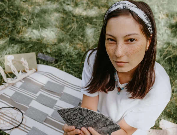 woman with tarot cards on a picnic