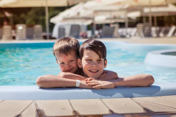 Two brothers near the pool on a summer day