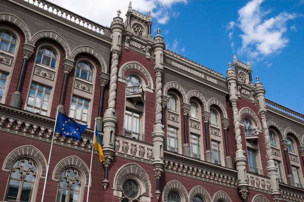 The facade of the National Bank of Ukraine in 2020 with European Union and Ukrainian flags in the front