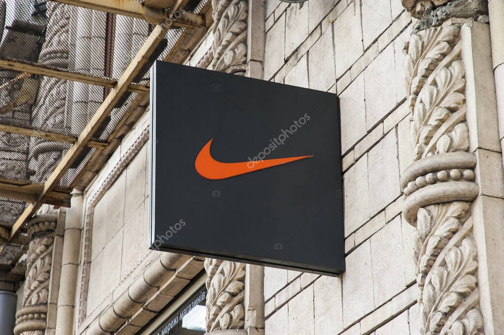 Kyiv / Ukraine - July 31, 2020: Orange Nike logo on a sign fixed to the wall at an official Nike store