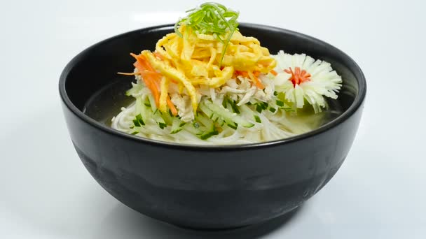 韓国の冷麺スープ韓国の伝統的な食べ物人気のある夏の料理彫刻ネギの花の形のサイドビューを飾る — ストック動画