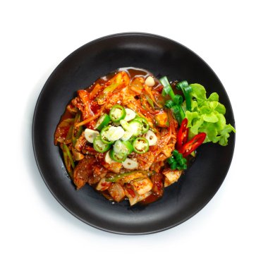 Baharatlı kimçi domuz eti (Dwaejigogi Kimchi Bokkeum) ile kızartılmış acı biber ve sarımsaklı Kore yemeği füzyon stili sebzeleri ve taze soğan beyaz arka plan manzarasını süslüyor.