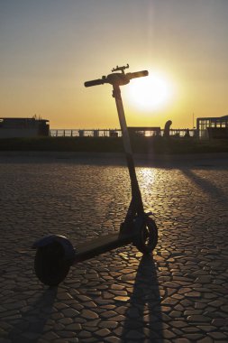 Landscape with scooter in backlight at dawn