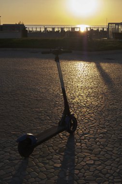 Landscape with scooter in backlight at dawn