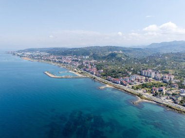 Trabzon, Türkiye 'deki Arsin ve Yomra' nın insansız hava aracı görüntüsü. Karadeniz kıyı şeridi yeşil tepeler ve yerleşim alanlarıyla birleşerek doğa, deniz ve kentsel manzaranın çarpıcı bir kombinasyonunu sunuyor..