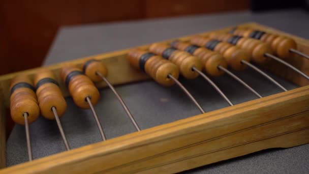 Mans Hand counts money in the accounts. Calculate financial matters on simple abacus — Stock Video