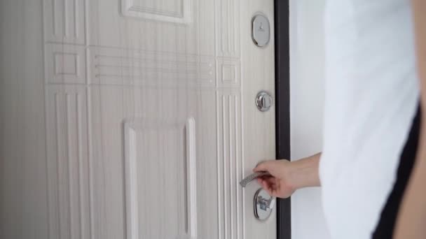 Man opens Deadbolt Door and get out of the house. Exits and comes the front door. Unlock Door and man entering to the room — Stock Video