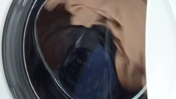 Washing things in the washing machine. The rotation of the drum of the washing machine close-up — Stock Video