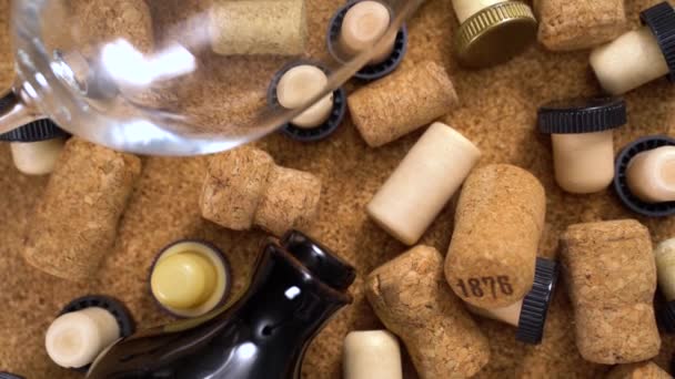 Smooth zoom out. Closeup of wine corks, glasses, bottle on a brown background — Stock Video