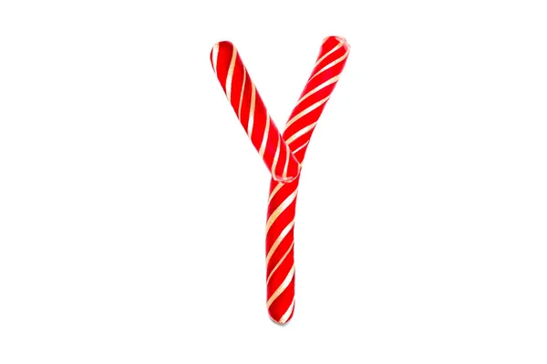 Símbolo Y creado a partir de dulces rojos decorativos festivos. Y texto de vacaciones hecho de caña de caramelo rojo . — Foto de Stock