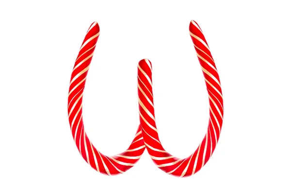 Vánoční cukrová třtina ve formě dopisu W. Dopis W vyrobený z červené cukrové třtiny Izolované na bílém pozadí — Stock fotografie