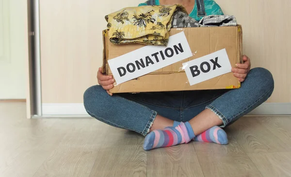 Cardboard box with clothes. Concept of donations