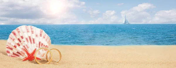 Rings on a sea background. Tropical island wedding concept