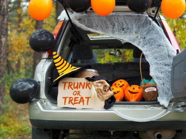 Trick or trunk. Concept celebrating Halloween in trunk of car. New trend celebrating traditional October holiday outdoor. Social distance and safe alternative celebration during coronavirus covid-19