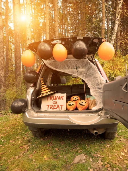 Trick or trunk. Concept celebrating Halloween in trunk of car. New trend celebrating traditional October holiday outdoor. Social distance and safe alternative celebration during coronavirus covid-19