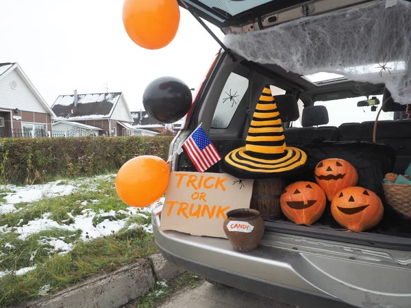 Trick or trunk. Concept celebrating Halloween in trunk of car. New trend celebrating traditional October holiday outdoor. Social distance and safe alternative celebration during coronavirus covid-19